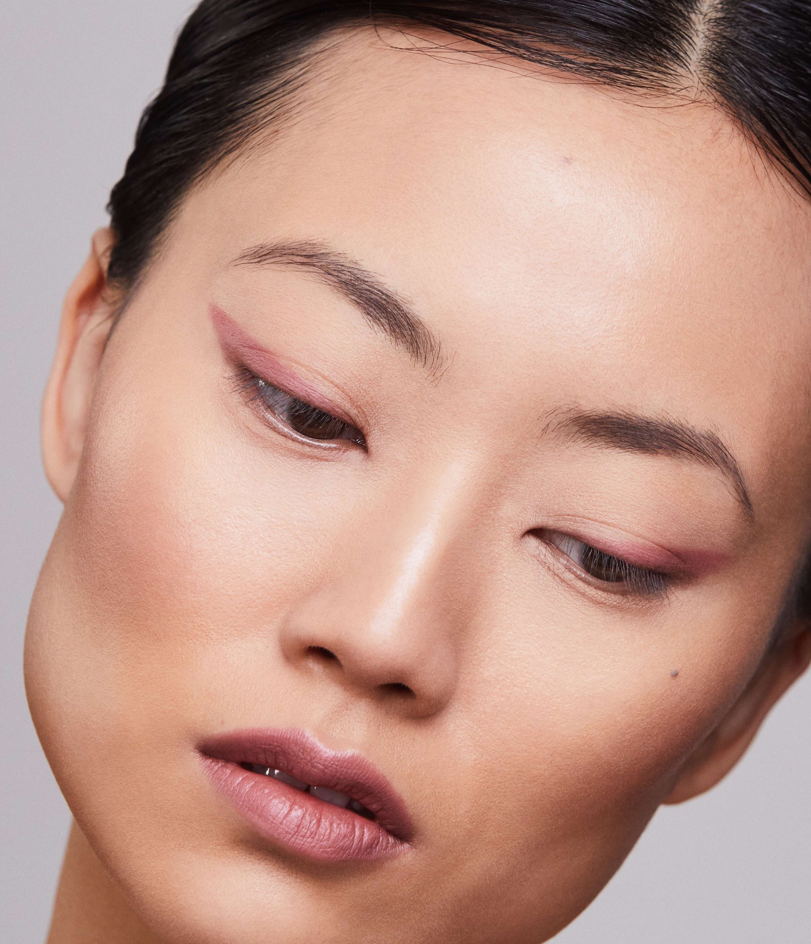 Close-up of a Model face wearing Aleph Eye/Lip Multi Liner Blush